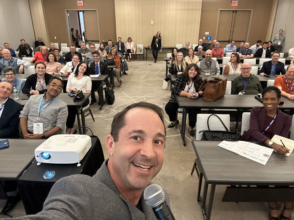 CurrentWave AI founder Pete Lunenfeld presenting to a room at Invest48